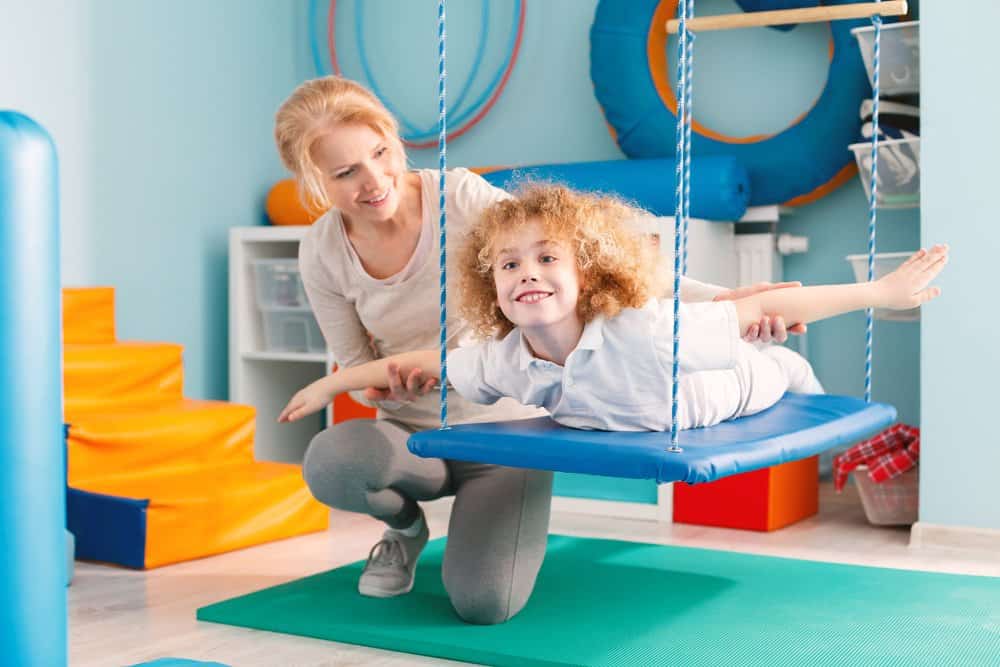 Young girl practicing balance with adult.